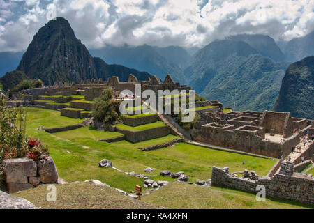 View of the Incan stone ruins at Machu Picchu, Peru with high mountain peaks in the Andes