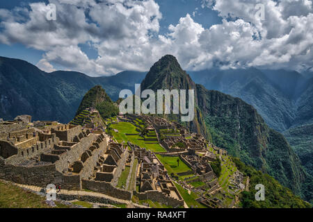Ruins of ancient Incas city of Machu Picchu an Peruvian Andes, with Huayna Picchu. Wide angle panoramic aerial view