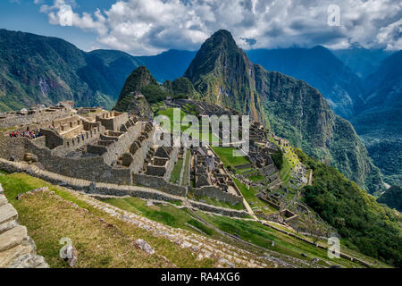 A view of the ruins of Machu Picchu, with steep Huayna Picchu mountain in the background. Peru, South America Stock Photo