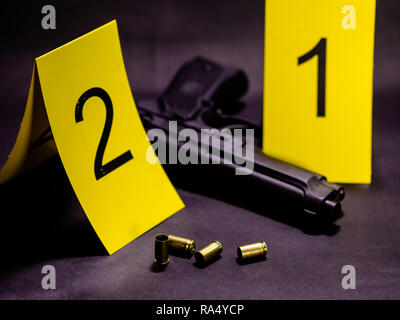 Bullets and gun next to markers at crime scene Stock Photo - Alamy