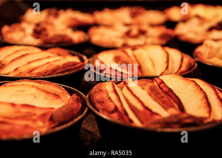 Small homemade apple pies freshly baked each in its mold Stock Photo
