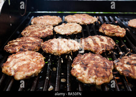 Homemade minced meat steaks on grill Stock Photo