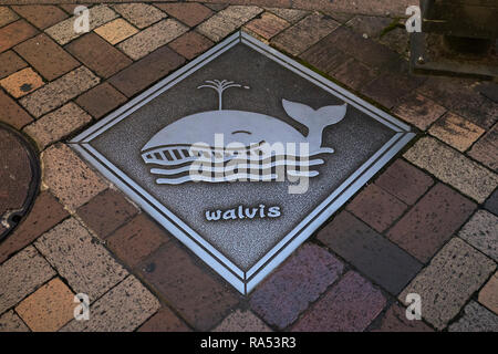 Nagasaki, Japan - October 24, 2018: Manhole cover art in Nagasaki with a whale and the dutch word Walvis