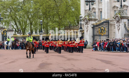 London, UK - April 29, 2018: Soldiers of the Royal Guard leave the Buckingham Palace during changing the guard ceremony. Stock Photo