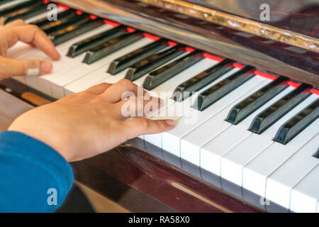 Female hands playing on old piano Stock Photo