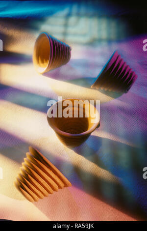 STILL LIFE OF CRUCIBLES, PAINTED WITH LIGHT  CREATING A COLOURFUL BACKGROUND AND TEXTURE Stock Photo