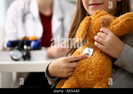 Female hand of little girl hold stethoscope listen Stock Photo