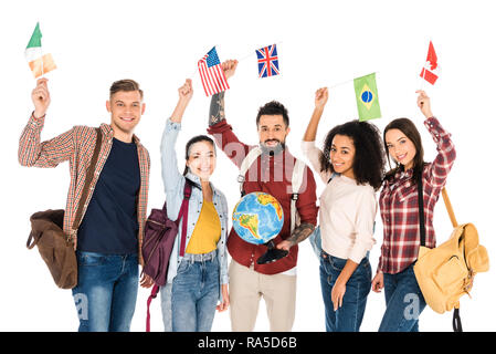 handsome man holding globe and standing with multiethnic group of people holding flags of different countries above heads isolated on white Stock Photo