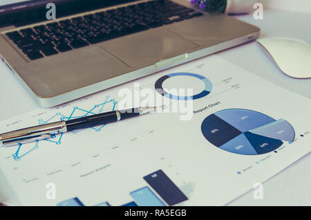 laptop with financial charts and graphs. Stock Photo