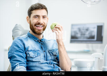 Portrait of a handsome bearded man with healthy smile in the dental office Stock Photo