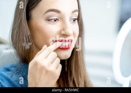 Portrait of a young woman with dental braces sitting in the dental office Stock Photo