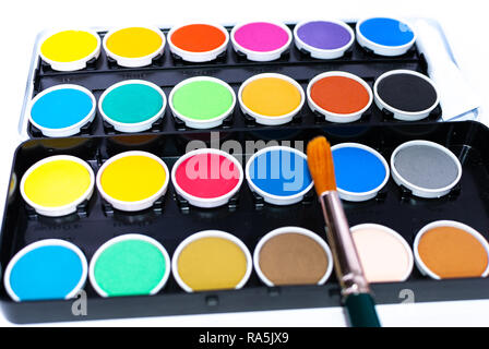 A colorful painting set and a paintbrush on white background Stock Photo