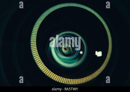 Abstract reflection on camera lens front element, colorful rings of light Stock Photo
