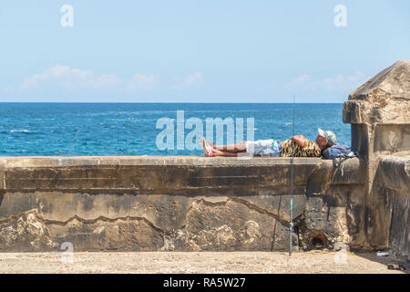 fisherman resting on wall at the Malecon in Havana, Cuba, Caribbean Stock Photo