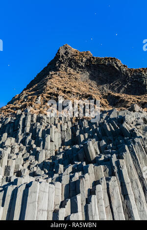 Columnar basalt formations along Reynisfjara Black Sand Beach in Iceland Stock Photo