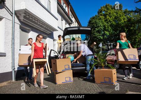 Private house move, people loading a station wagon, friends helping Stock Photo
