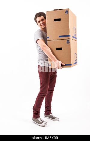 Young man carrying moving boxes Stock Photo