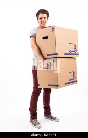 Young man carrying moving boxes Stock Photo