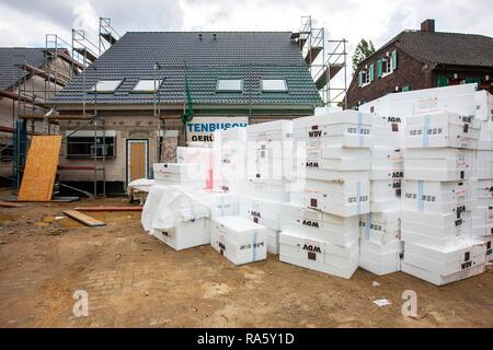 New construction of a single-family house, a stack of insulation material lying on the construction site Stock Photo