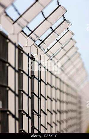 Security fence with barbed wire on top Stock Photo