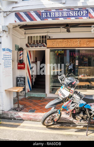 Singapore - 22nd December 2018: Motorbike outside a barber shop in Haji Lane. This is in the Kampong Glam area Stock Photo