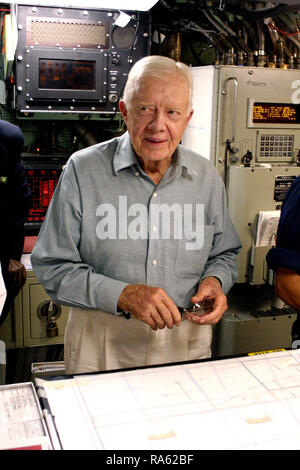2005 - Former US President Jimmy Carter (D) looks over the navigation table in the control room of his namesake ship, the Sea Wolf Class Attack Submarine USS JIMMY CARTER (SSN 23). President Carter and his wife, Rosalynn, spent the night aboard the submarine, touring the ship and meeting with crew members. The USS JIMMY CARTER is the third Sea Wolf Class Attack Submarine. Stock Photo