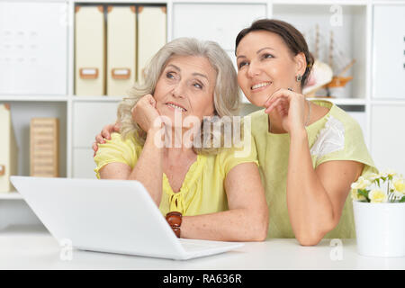 Portrait of mother and daughter using laptop Stock Photo