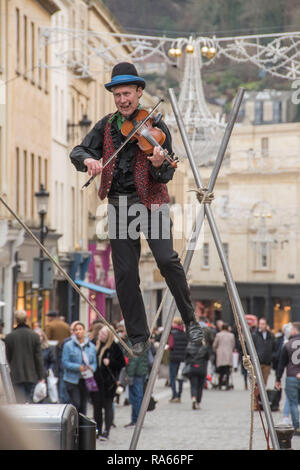 Bath, UK. 1st Jan 2019. A street entertainer plays his violin while walking on a tightrope in the centre of Bath, England on the first day of 2019 as crowds of shoppers make the most of the New Years Day sales. Credit: Phil Rees/Alamy Live News Stock Photo