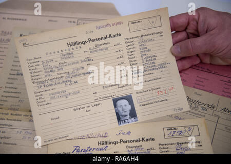 Bad Arolsen, Germany. 11th Dec, 2018. An employee of the International Tracing Service (ITS) is holding a 'Prisoner's Personal Card' in his hand in the provisional archive. The ITS is an archive and documentation centre on Nazi persecution and the liberated survivors. (to dpa 'International Tracing Service ITS' from 02.01.2019) Credit: Swen Pförtner/dpa/Alamy Live News