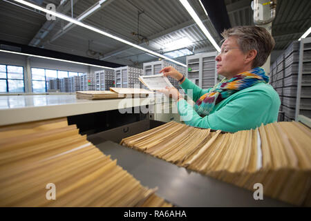 Bad Arolsen, Germany. 11th Dec, 2018. Nicole Dominicus, Head of Archive Administration, holds maps of the Central Name Index (ZNK) at a file cabinet in the provisional archive of the International Tracing Service (ITS). The ITS is an archive and documentation centre on Nazi persecution and the liberated survivors. (to dpa 'International Tracing Service ITS' from 02.01.2019) Credit: Swen Pförtner/dpa/Alamy Live News