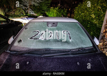 Lixwm, North Wales UK. 2nd Jan, 2019. UK Weather: A severe drop in temperatures overnight and the first frost of 2019 with the numbers and year 2019 written into a mortorist's vehicle before clearing this morning in the village of Lixwm, Wales Credit: DGDImages/Alamy Live News Stock Photo