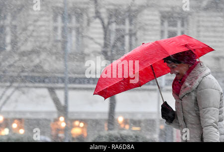 Prague, Czech Republic. 02nd Jan, 2019. A woman with an umbrella is seen during snowing in Prague, Czech Republic, on January 2, 2019. Credit: Vit Simanek/CTK Photo/Alamy Live News Stock Photo