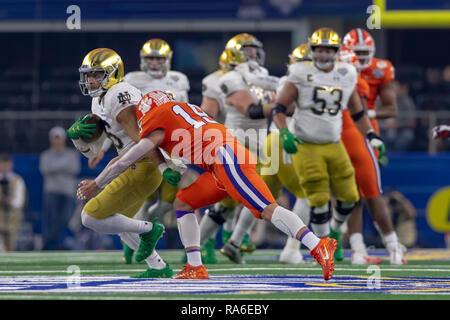 Arlington, Texas, USA. 29th Dec, 2018. December 29, 2018 - Arlington, Texas, U.S. - Notre Dame Fighting Irish tight end Alize Mack (86) is tackled by Clemson Tigers safety Tanner Muse (19) in the College Football Playoff Semifinal at the Goodyear Cotton Bowl Classic between the Notre Dame Fighting Irish and the Clemson Tigers at AT&T Stadium, Arlington, Texas. Clemson won 30-3 to advance to the National Championship game. Credit: Adam Lacy/ZUMA Wire/Alamy Live News Stock Photo