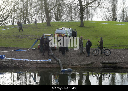 Basildon, Essex, UK. 2nd Jan 2019. Essex Police officers along with the Environmental Agency drain the fishing lake in Gloucester Park Basildon Essex in the search for a missing 28 year old man. Jack Morrad was last seen at 2:30am on CCTV on Sunday December 23 in nearby Blake Avenue. Throughout the festive period Police officers and Jack's family and friends have carried out searches of the park and surrounding waterways. Following the conclusion of these searches it was decided to completely drain the main fishing lake. Credit: MARTIN DALTON/Alamy Live News Stock Photo