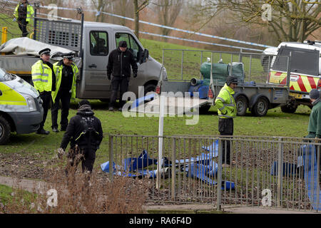 Basildon, Essex, UK. 2nd Jan 2019. Essex Police officers along with the Environmental Agency drain the fishing lake in Gloucester Park Basildon Essex in the search for a missing 28 year old man. Jack Morrad was last seen at 2:30am on CCTV on Sunday December 23 in nearby Blake Avenue. Throughout the festive period Police officers and Jack's family and friends have carried out searches of the park and surrounding waterways. Following the conclusion of these searches it was decided to completely drain the main fishing lake. Credit: MARTIN DALTON/Alamy Live News Stock Photo