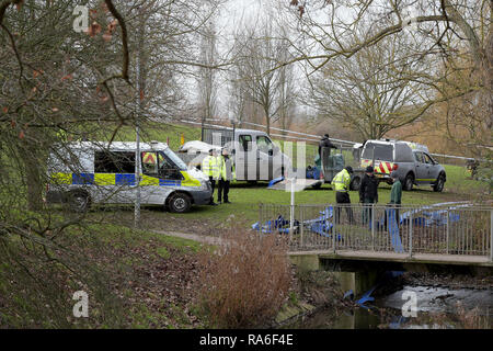 Basildon, Essex, UK. 2nd Jan 2019. Essex Police officers along with the Environmental Agency drain the fishing lake in Gloucester Park Basildon Essex in the search for a missing 28 year old man. Jack Morrad was last seen at 2:30am on CCTV on Sunday December 23 in nearby Blake Avenue. Throughout the festive period Police officers and Jack's family and friends have carried out searches of the park and surrounding waterways. Following the conclusion of these searches it was decided to completely drain the main fishing lake. Credit: MARTIN DALTON/Alamy Live News Stock Photo