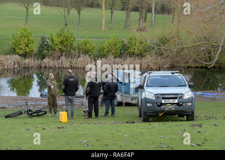 Basildon, Essex, UK. 2nd Jan 2019. Essex Police officers along with the Environmental Agency drain the fishing lake in Gloucester Park Basildon Essex in the search for a missing 28 year old man. Jack Morrad was last seen at 2:30am on CCTV on Sunday December 23 in nearby Blake Avenue. Throughout the festive period Police officers and Jack's family and friends have carried out searches of the park and surrounding waterways. Following the conclusion of these searches it was decided to completely drain the main fishing lake. Credit: MARTIN DALTON/Alamy Live News Stock Photo