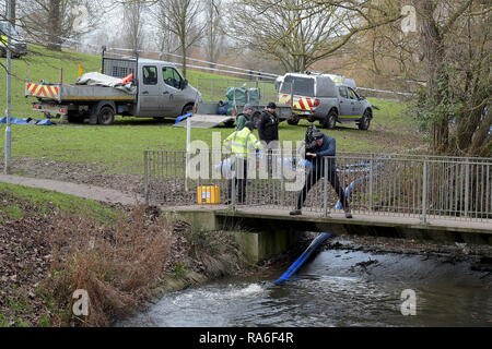 Basildon, Essex, UK. 2nd Jan 2019. Essex Police officers along with the Environmental Agency drain the fishing lake in Gloucester Park Basildon Essex in the search for a missing 28 year old man. Jack Morrad was last seen at 2:30am on CCTV on Sunday December 23 in nearby Blake Avenue. Throughout the festive period Police officers and Jack's family and friends have carried out searches of the park and surrounding waterways. Following the conclusion of these searches it was decided to completely drain the main fishing lake. Credit: MARTIN DALTON/Alamy Live News Stock Photo