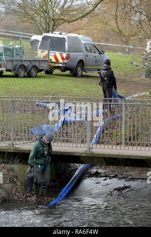 Basildon, Essex, UK. 2nd Jan 2019. Essex Police officers along with the Environmental Agency drain the fishing lake in Gloucester Park Basildon Essex in the search for a missing 28 year old man. Jack Morrad was last seen at 2:30am on CCTV on Sunday December 23 in nearby Blake Avenue. Throughout the festive period Police officers and Jack's family and friends have carried out searches of the park and surrounding waterways. Following the conclusion of these searches it was decided to completely drain the main fishing lake. Credit: MARTIN DALTON/Alamy Live News Stock Photo