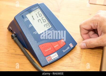 Blood pressure measurement, with an automatic upper arm blood pressure monitor, Germany Stock Photo