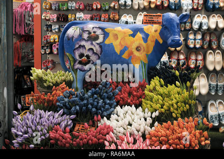 Souvenir store in Amsterdam with traditional symbols of Holland. A cow, Tulips and clogs Stock Photo