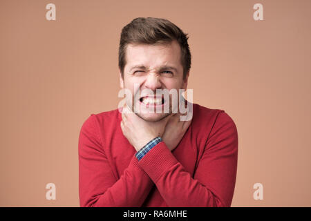 Young man having asthma attack or choking can not breath suffering from respiration problems Stock Photo