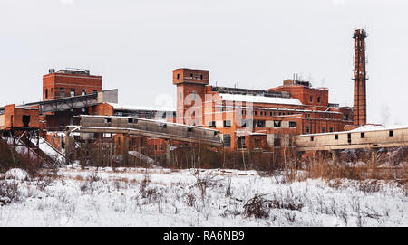 Old ruined factory construction in winter time. Urban exploration photography Stock Photo