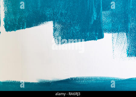 White wall being painted in blue or aqua or teal color. Background with copy space. Stock Photo