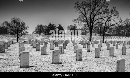 Saint Louis, MO--Mar 11, 2018; snow falling on Jefferson Barracks National Cemetery headstones, largest veterans burial gourd west of Mississippi Stock Photo