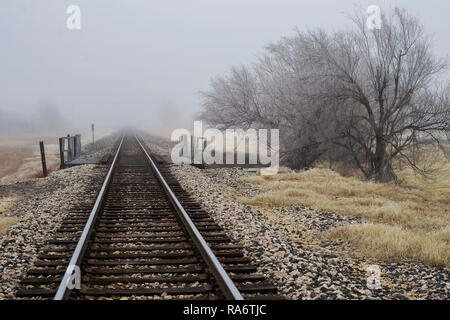 Railroad tracks in Alpine, Texas, on a foggy winter evening. Stock Photo