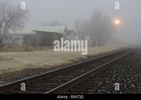 Railroad tracks in Alpine, Texas, on a foggy winter evening. Stock Photo