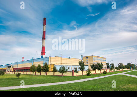 pipes of woodworking enterprise plant sawmill in the morning dawn. Air pollution concept. Industrial landscape environmental pollution waste of therma Stock Photo