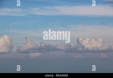Blue sky and clouds of light pink color, floating in the sky Stock Photo