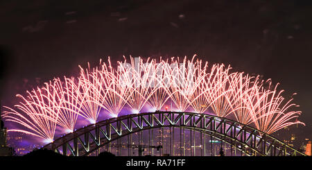 Top part of the Sydney Harbour bridge still arch with New Year mignight fireworks light show against dark sky as part of national celebrations. Stock Photo